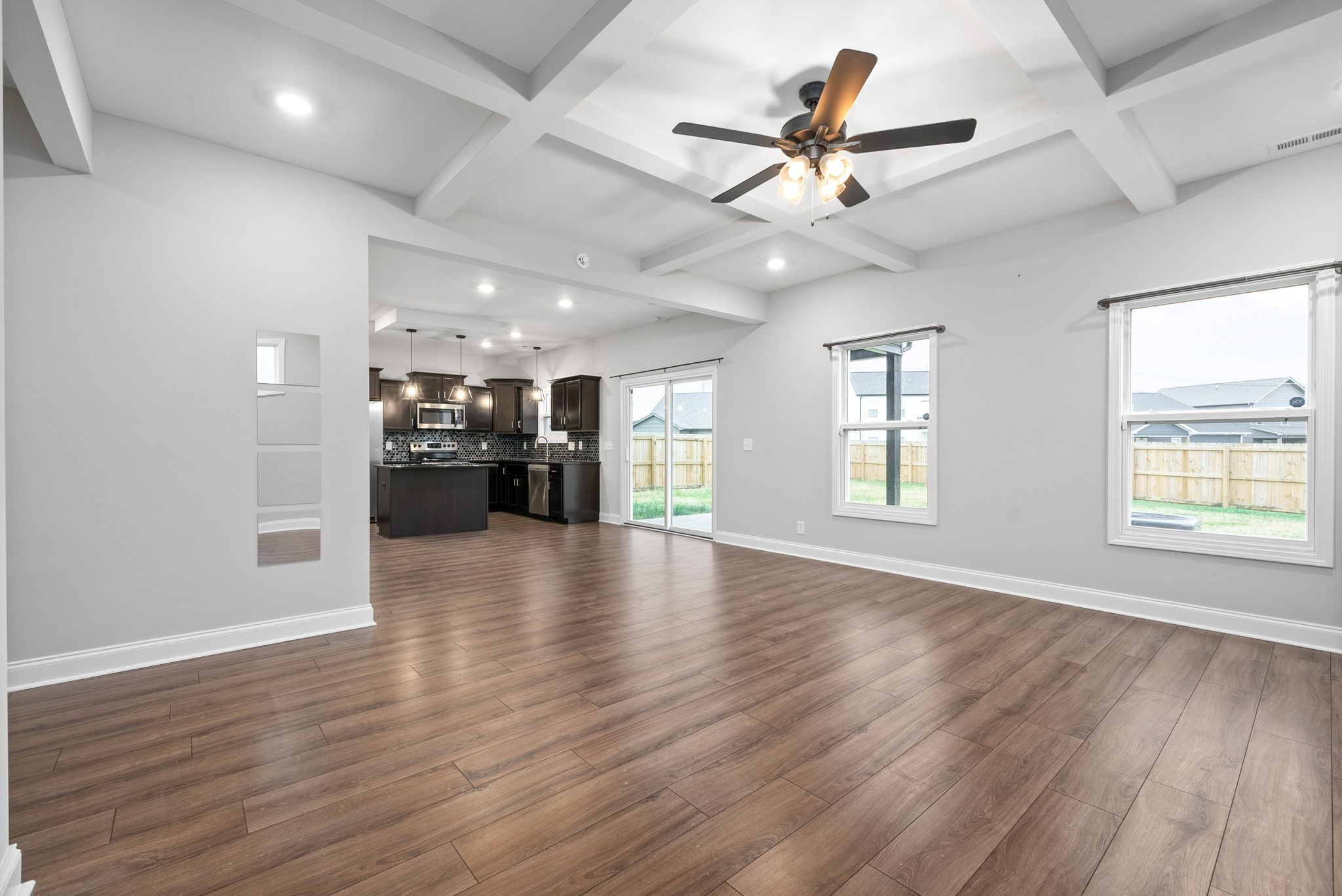 202 Copeland Road Clarksville, TN 37042 - Photo 5 of 19 a view of an empty room with a kitchen and wooden floor
