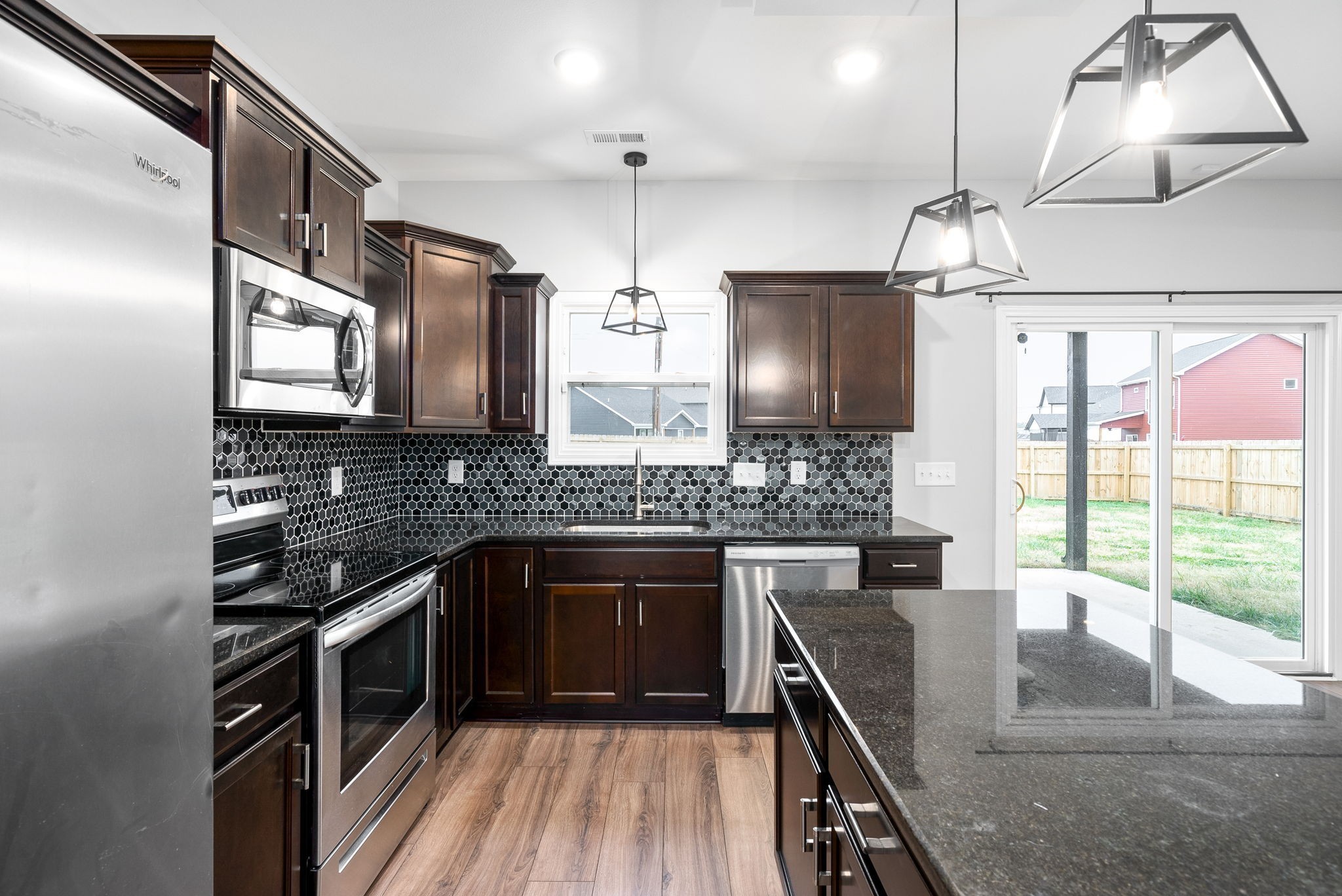 202 Copeland Road Clarksville, TN 37042 - Photo 8 of 19 a kitchen with stainless steel appliances granite countertop a stove a sink and a refrigerator