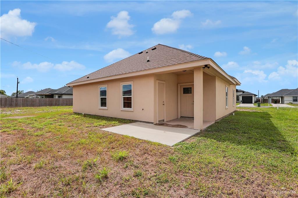 824 Lark Street Alamo, TX 78516 - Photo 17 of 17 Back of property featuring a patio, stucco siding, and a shingled roof