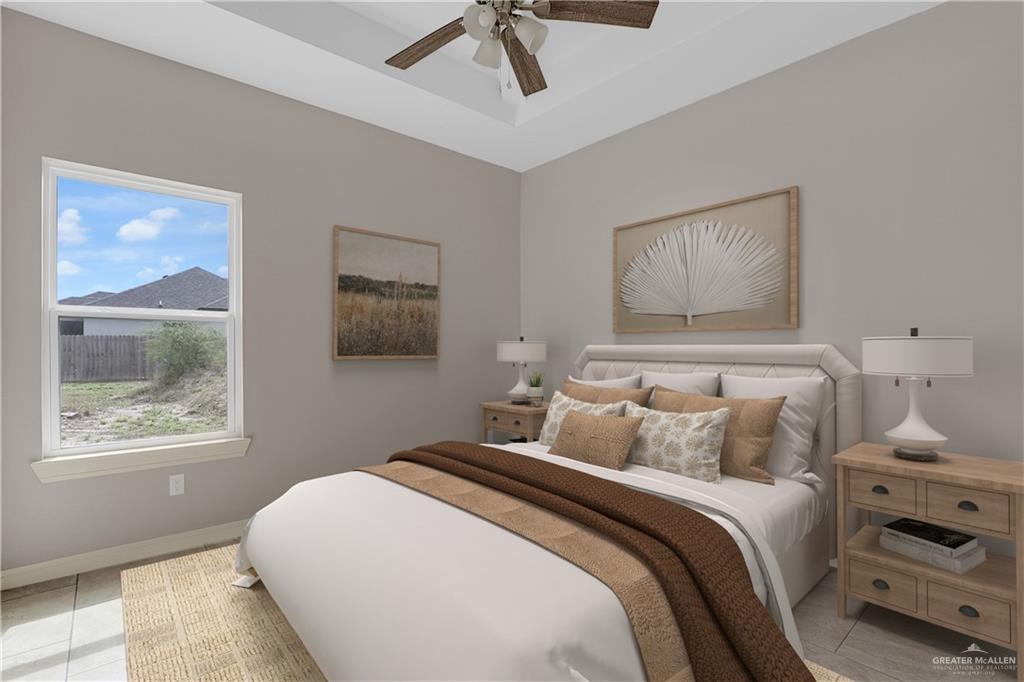 824 Lark Street Alamo, TX 78516 - Photo 5 of 17 Bedroom with light tile patterned floors, a tray ceiling, and a ceiling fan