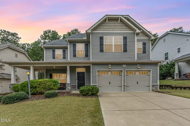 a front view of a house with a yard and garage