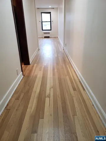 wooden floor in a room next to a window