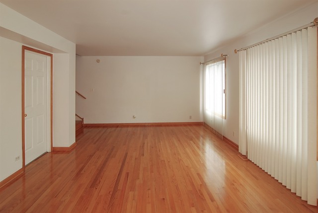 7290 Ogden Avenue, Unit 2 Riverside, IL 60546 - Photo 2 of 10 an empty room with wooden floor and windows