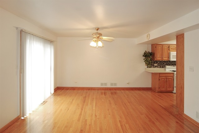 7290 Ogden Avenue, Unit 2 Riverside, IL 60546 - Photo 3 of 10 a view of a kitchen with a stove cabinets and wooden floor