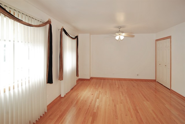 7290 Ogden Avenue, Unit 2 Riverside, IL 60546 - Photo 5 of 10 wooden floor in an empty room with a window