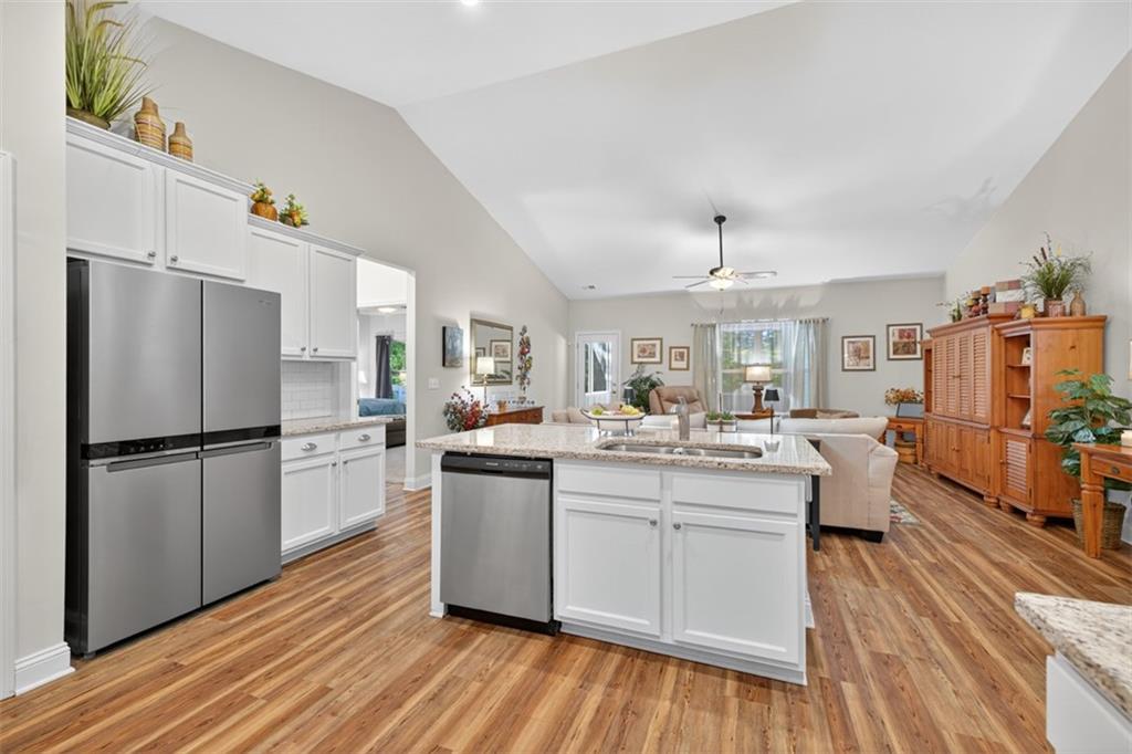 829 River Fall Drive Jefferson, GA 30549 - Photo 11 of 63 a kitchen with kitchen island white cabinets and stainless steel appliances