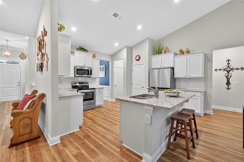829 River Fall Drive Jefferson, GA 30549 - Photo 12 of 63 a kitchen with stainless steel appliances granite countertop a refrigerator and a stove top oven