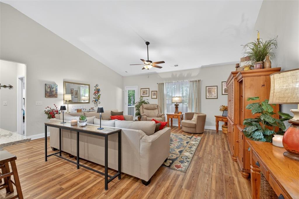 829 River Fall Drive Jefferson, GA 30549 - Photo 17 of 63 a living room with furniture and a wooden floor