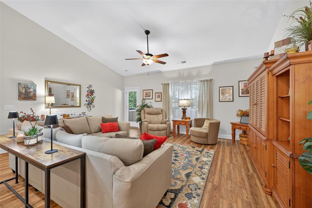 829 River Fall Drive Jefferson, GA 30549 - Photo 18 of 63 a living room with furniture a chandelier and a table