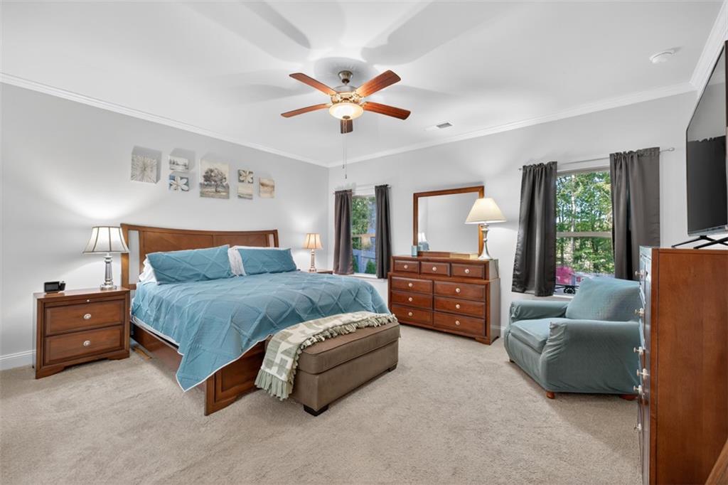 829 River Fall Drive Jefferson, GA 30549 - Photo 27 of 63 a spacious bedroom with a bed and a couch