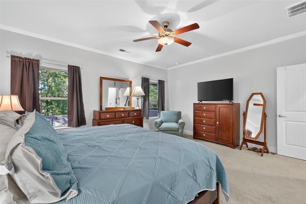 829 River Fall Drive Jefferson, GA 30549 - Photo 28 of 63 a bedroom with a bed flat screen tv and a large window