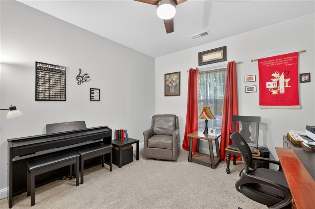 829 River Fall Drive Jefferson, GA 30549 - Photo 36 of 63 a living room with furniture gym equipment and a flat screen tv