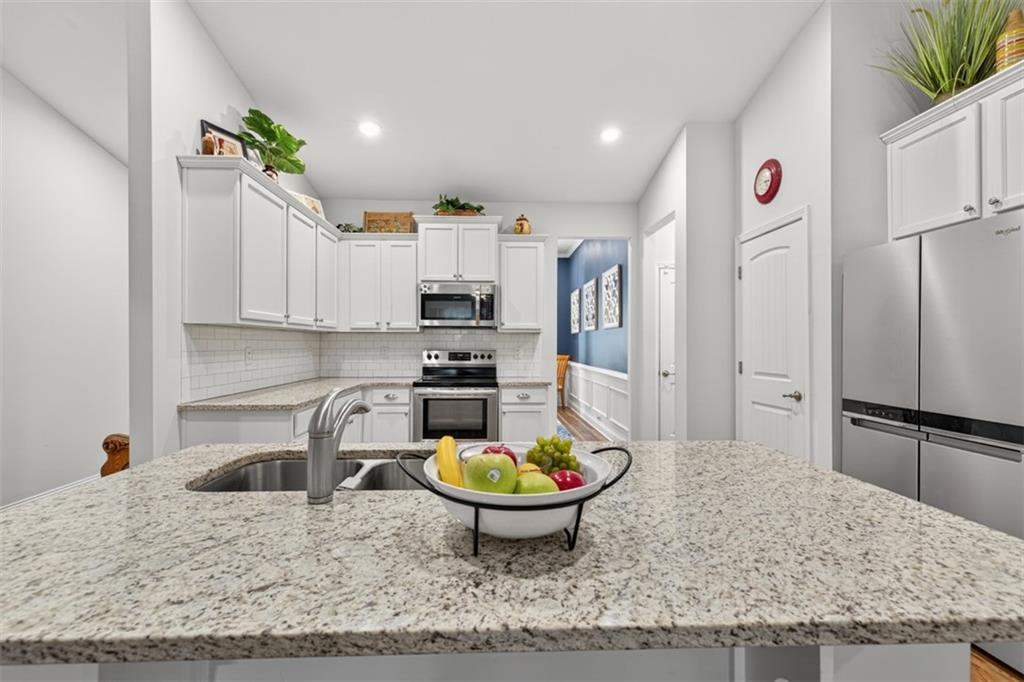 829 River Fall Drive Jefferson, GA 30549 - Photo 9 of 63 a kitchen with stainless steel appliances kitchen island granite countertop a refrigerator and a sink