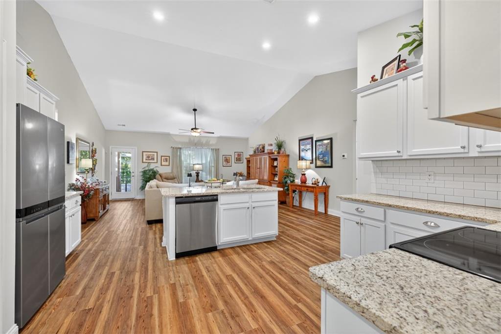 829 River Fall Drive Jefferson, GA 30549 - Photo 10 of 63 a large kitchen with cabinets wooden floor and stainless steel appliances