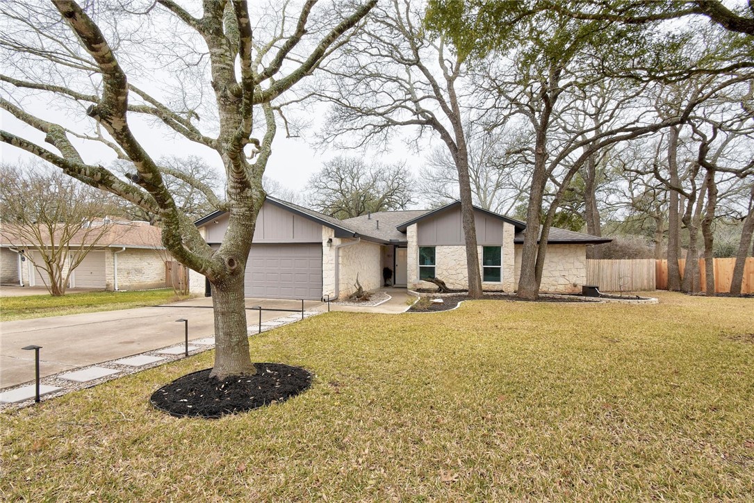a white house that has a tree in front of it
