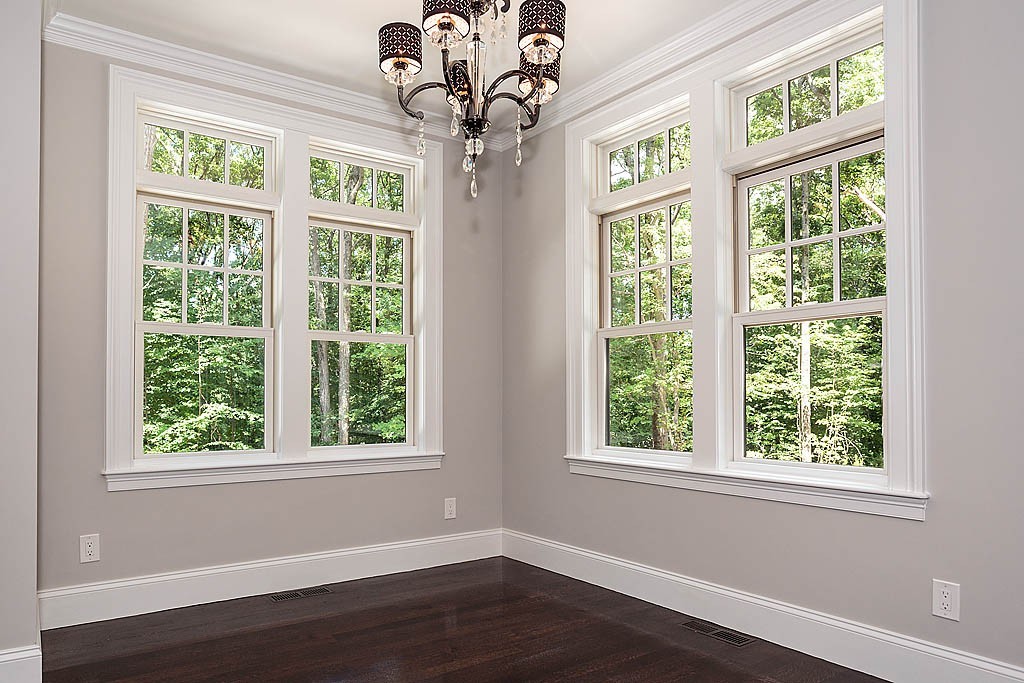 211 Sandy Pond Road Lincoln, MA 01773 - Photo 13 of 22 a view of an empty room with wooden floor and windows
