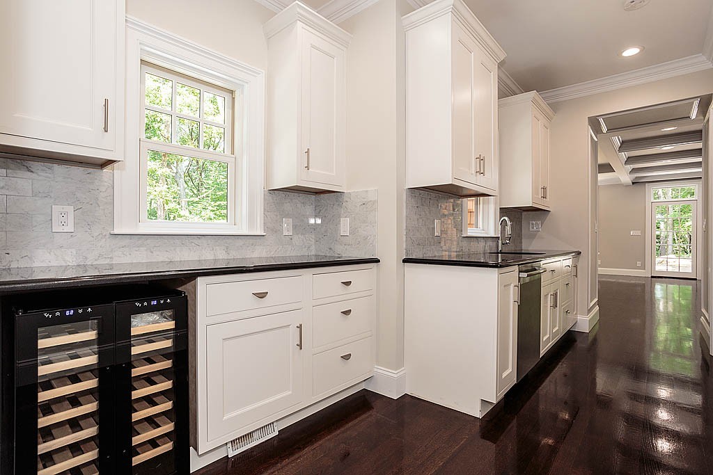 211 Sandy Pond Road Lincoln, MA 01773 - Photo 14 of 22 a kitchen with granite countertop white cabinets and a window
