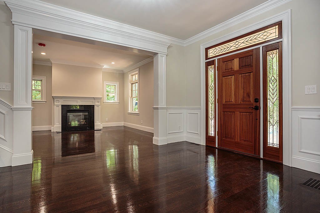 211 Sandy Pond Road Lincoln, MA 01773 - Photo 2 of 22 wooden floor in an empty room with a fireplace