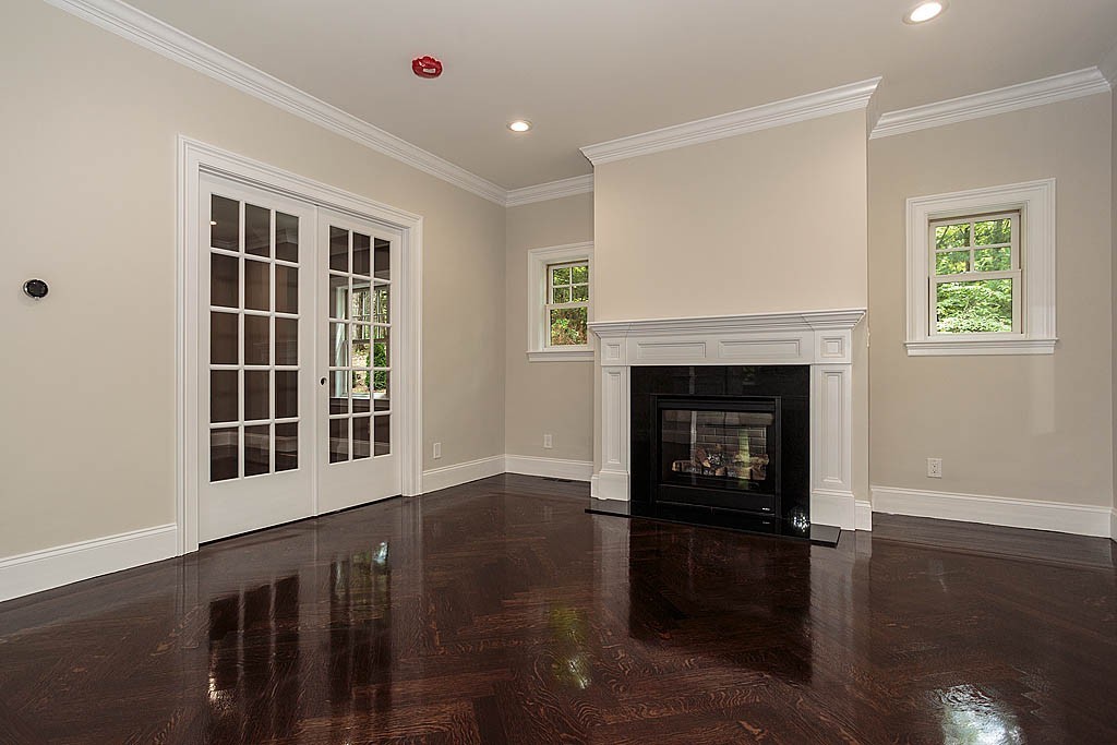 211 Sandy Pond Road Lincoln, MA 01773 - Photo 3 of 22 a living room with a fireplace and wooden floor