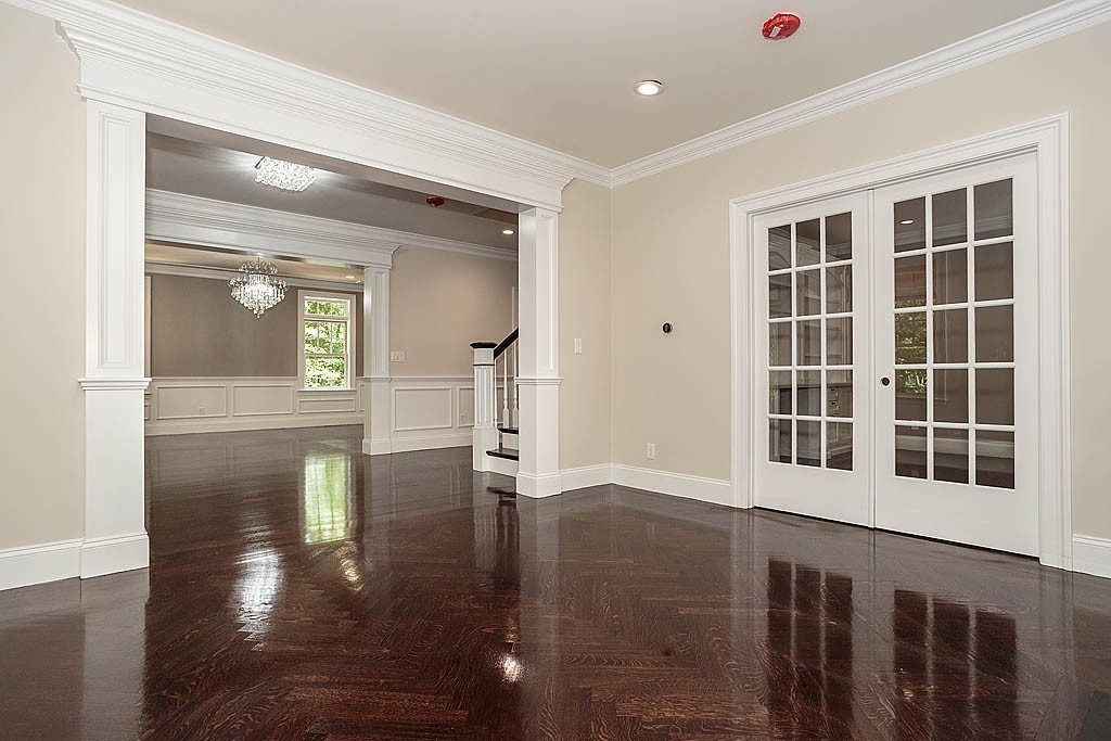 211 Sandy Pond Road Lincoln, MA 01773 - Photo 4 of 22 a view of a hallway with wooden floor and a window