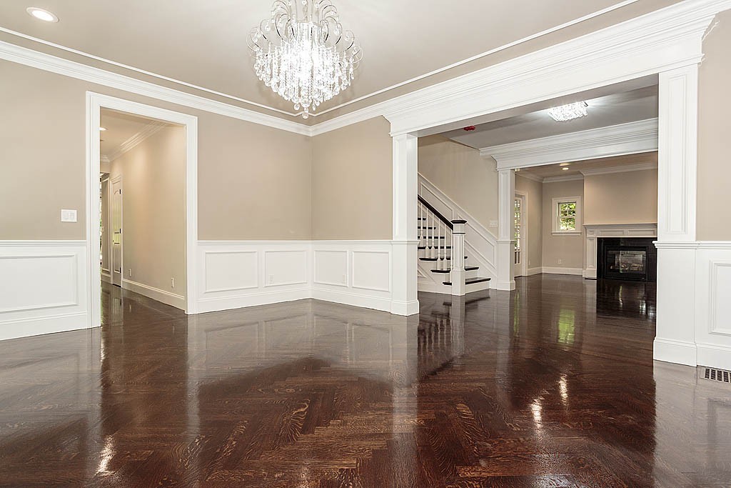211 Sandy Pond Road Lincoln, MA 01773 - Photo 9 of 22 a view of a hallway view with fireplace and chandelier