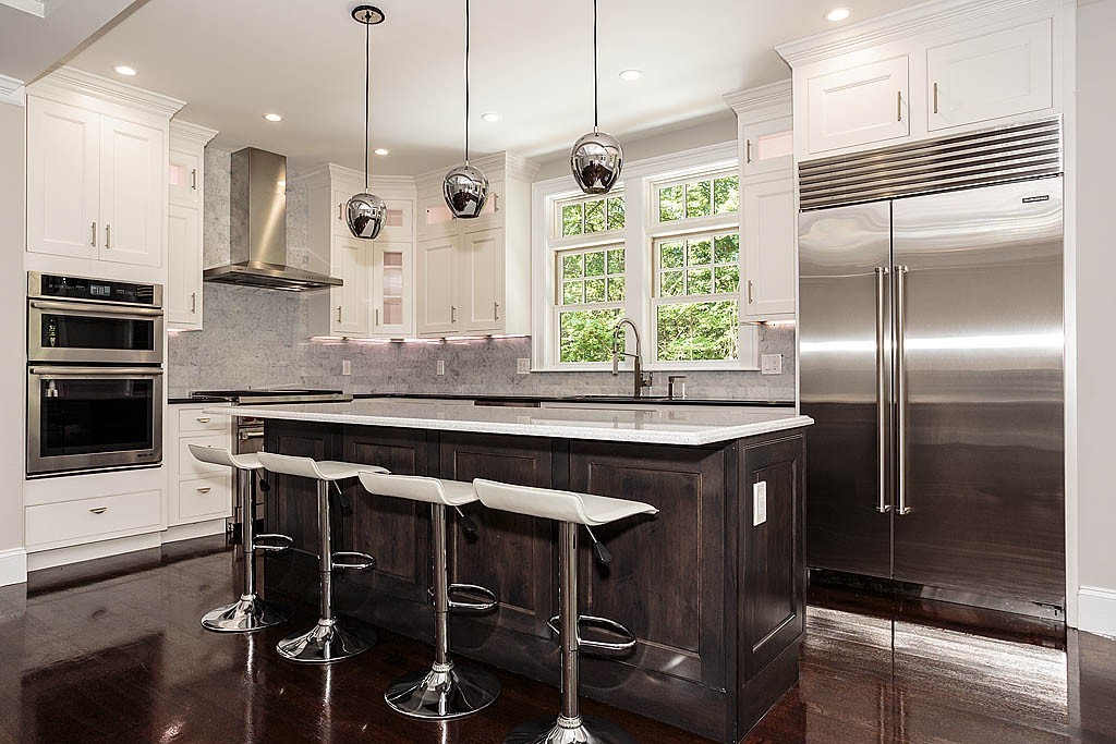 211 Sandy Pond Road Lincoln, MA 01773 - Photo 10 of 22 a kitchen with a table chairs refrigerator and stove