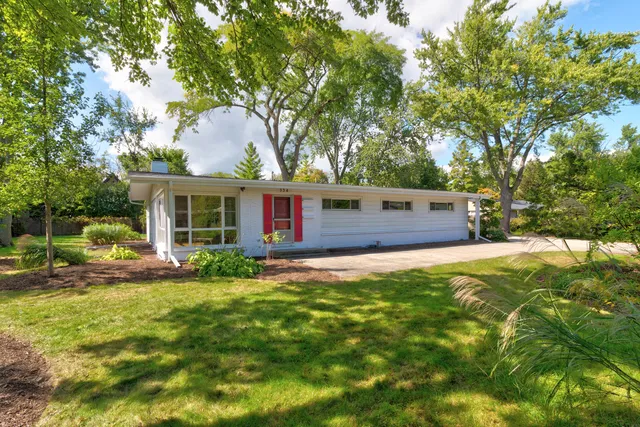 a view of a house with a yard and trees