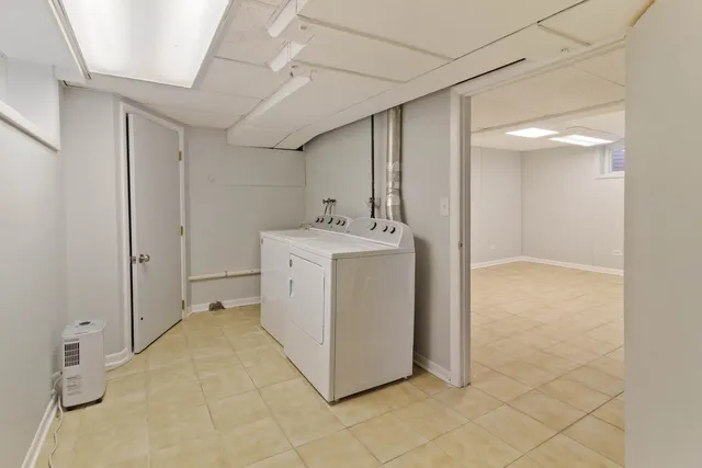a utility room with cabinets washer and dryer