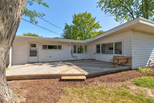 a view of a house with snow on the side of the road