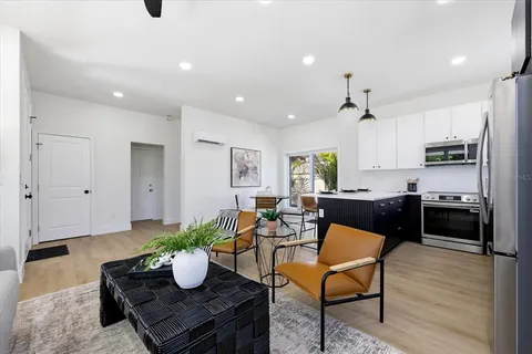 a kitchen with a refrigerator and a dining table