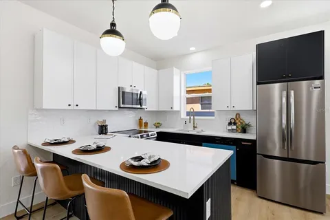 a kitchen with a refrigerator a stove a sink and a refrigerator