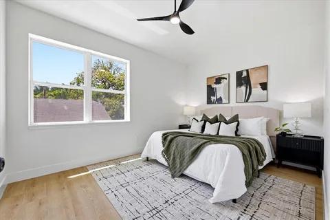 a bedroom with a bed and lamps