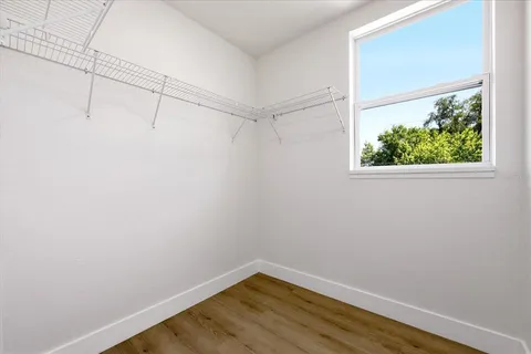 a view of empty room with wooden floor