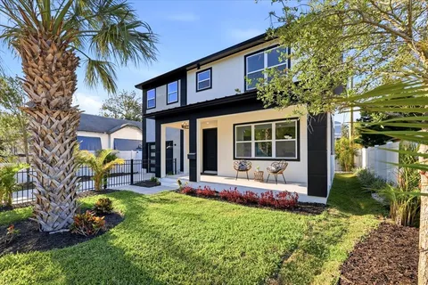 a view of a house with sitting area and garden