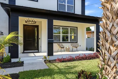 a front view of a house with a garden