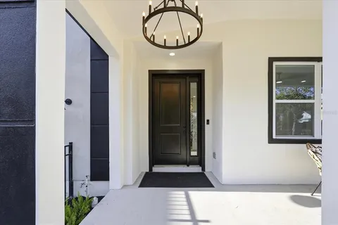 a front view of a house with a large window and mirror