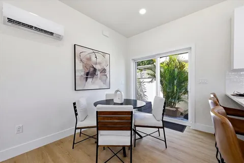 a dining room with furniture and wooden floor
