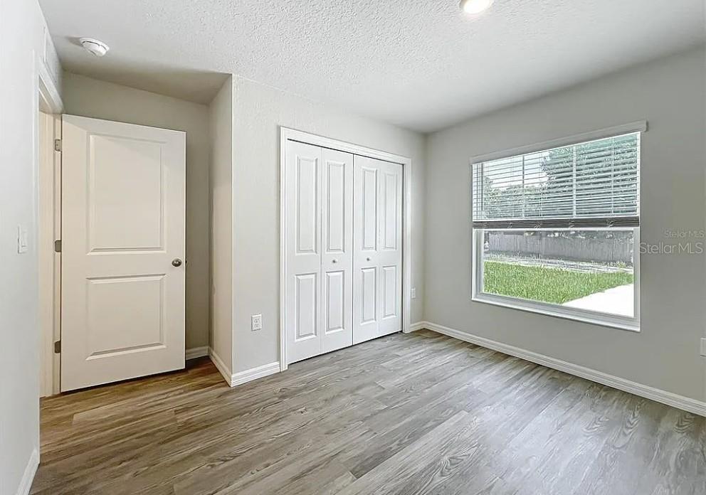 1145 South Apopka Avenue Inverness, FL 34452 - Photo 11 of 13 an empty room with wooden floor and windows