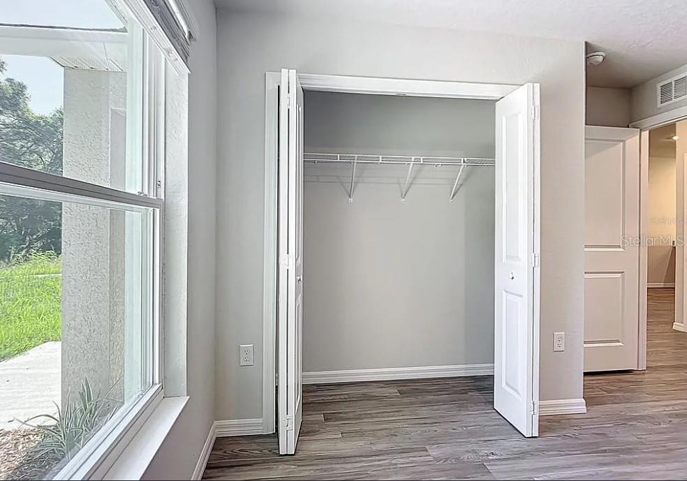 1145 South Apopka Avenue Inverness, FL 34452 - Photo 12 of 13 a view of an empty room with wooden floor and a window