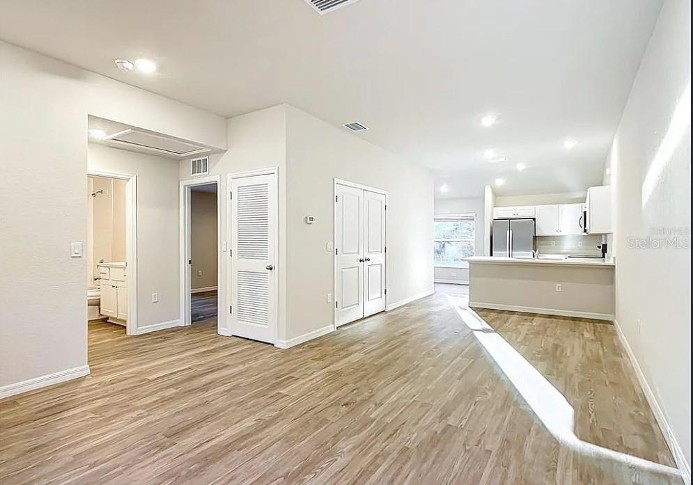 1145 South Apopka Avenue Inverness, FL 34452 - Photo 3 of 13 a view of a kitchen with wooden floor and a window