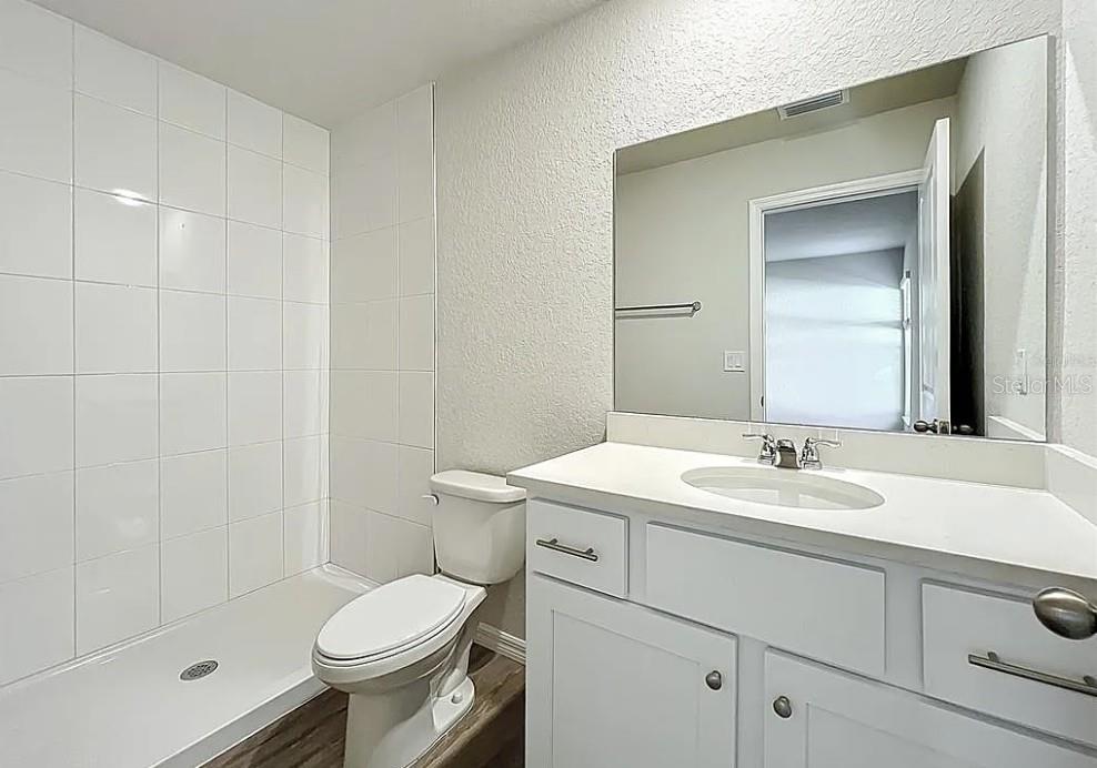 1145 South Apopka Avenue Inverness, FL 34452 - Photo 9 of 13 a bathroom with a sink toilet vanity and shower