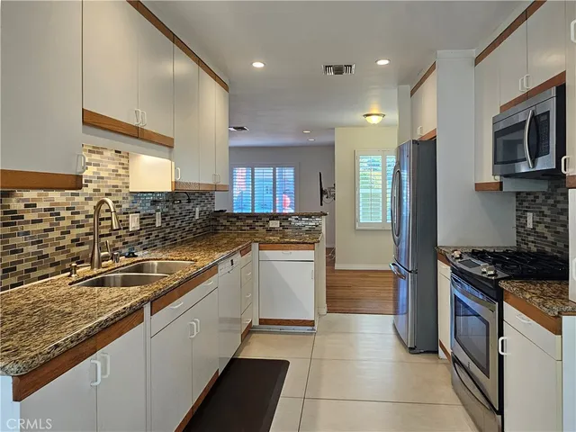 a kitchen with a sink stove and refrigerator