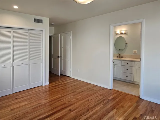 a view of a room with wooden floor and cabinet