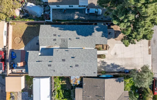 an aerial view of a house with swimming pool and ocean view