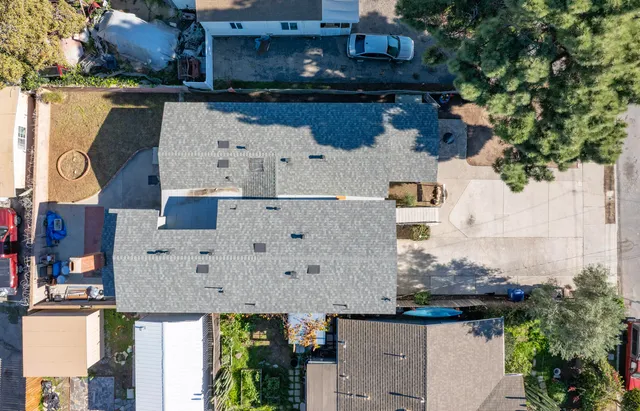an aerial view of a house with swimming pool and ocean view