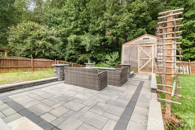 an empty room with wooden floor and ceiling fan