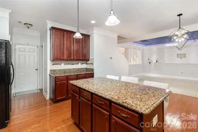 a kitchen with stainless steel appliances granite countertop wooden cabinets a refrigerator and a stove