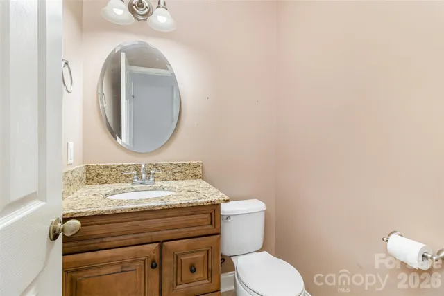 a view of empty room with wooden floor and ceiling fan