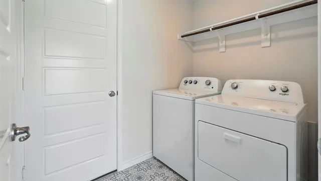 a view of storage and utility room with washer and dryer
