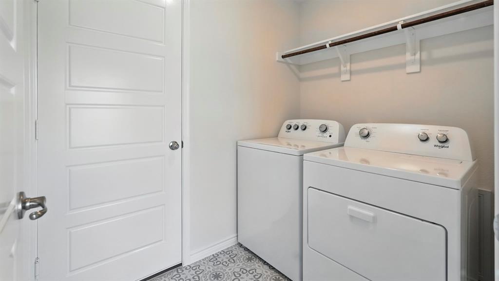 9820 Amalgam Street Aubrey, TX 76227 - Photo 12 of 40 a view of storage and utility room with washer and dryer